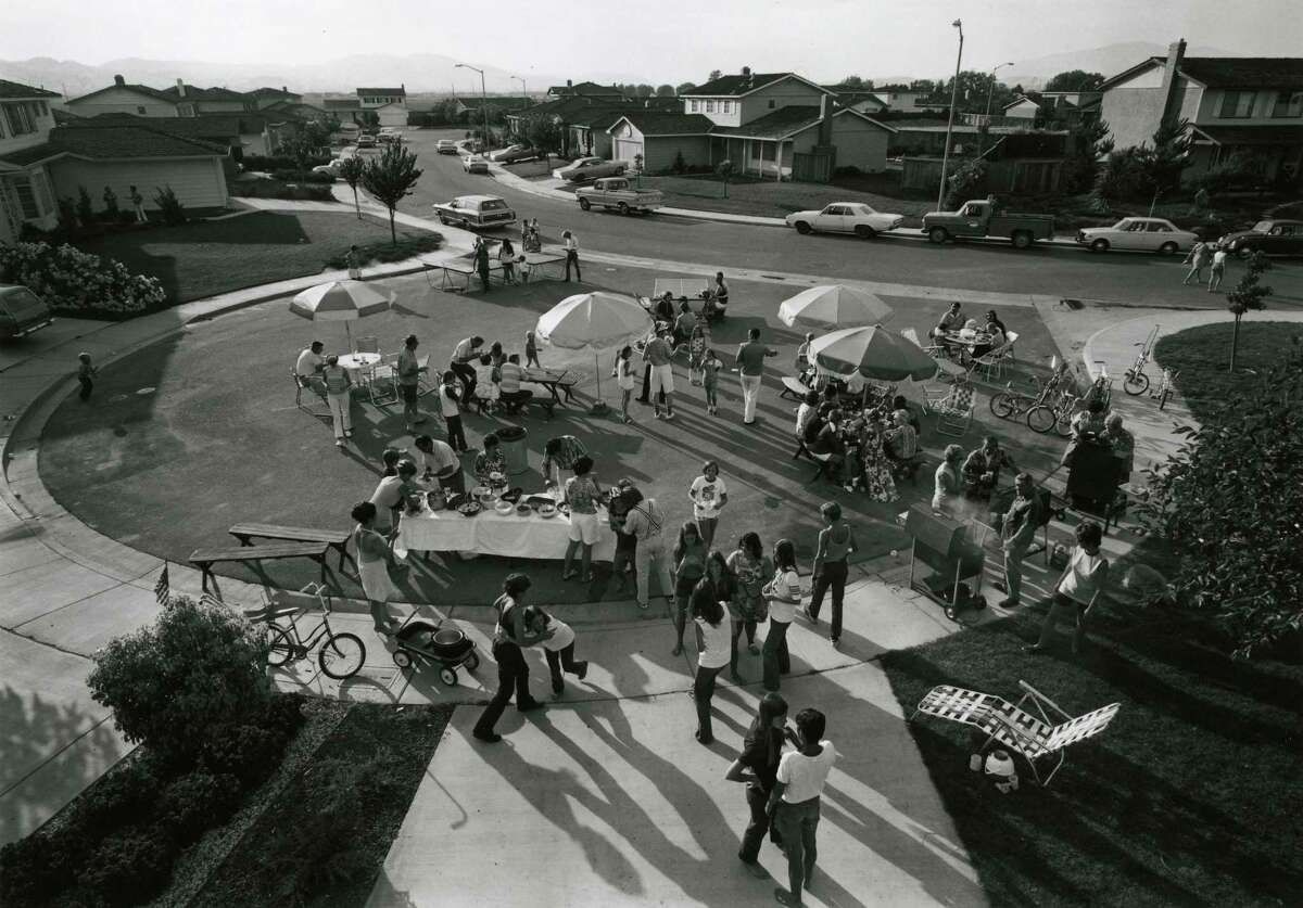 From “Suburbia”: “Fourth of July block party. This year thirty-three families came for beer, barbecued chicken, corn on the cob, potato salad, green salad, macaroni salad, and watermelon.”