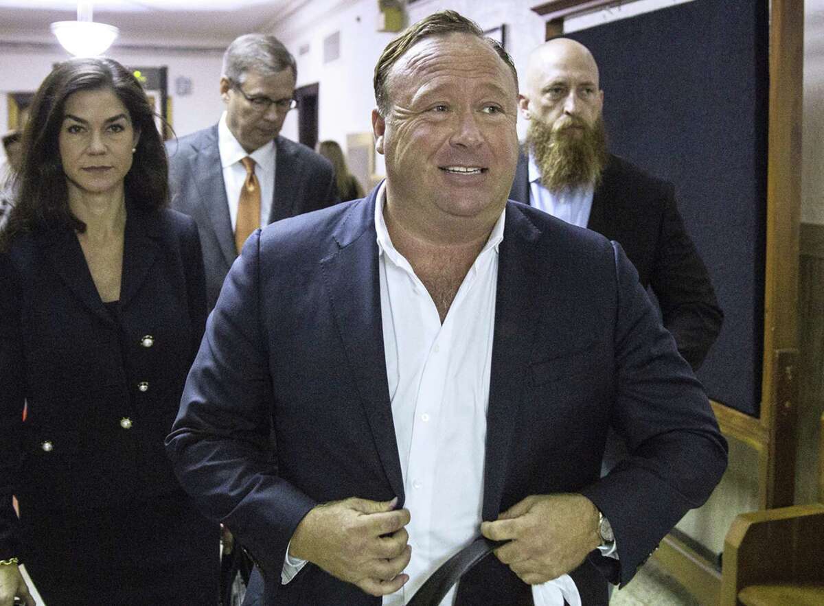 "Infowars" host Alex Jones arrives at the Travis County Courthouse in Austin, Texas. Jones filed a motion Friday, July 20, 2018, to dismiss a defamation lawsuit filed by families of some of the 26 people killed in the 2012 Sandy Hook school shooting in Newtown, Conn.
