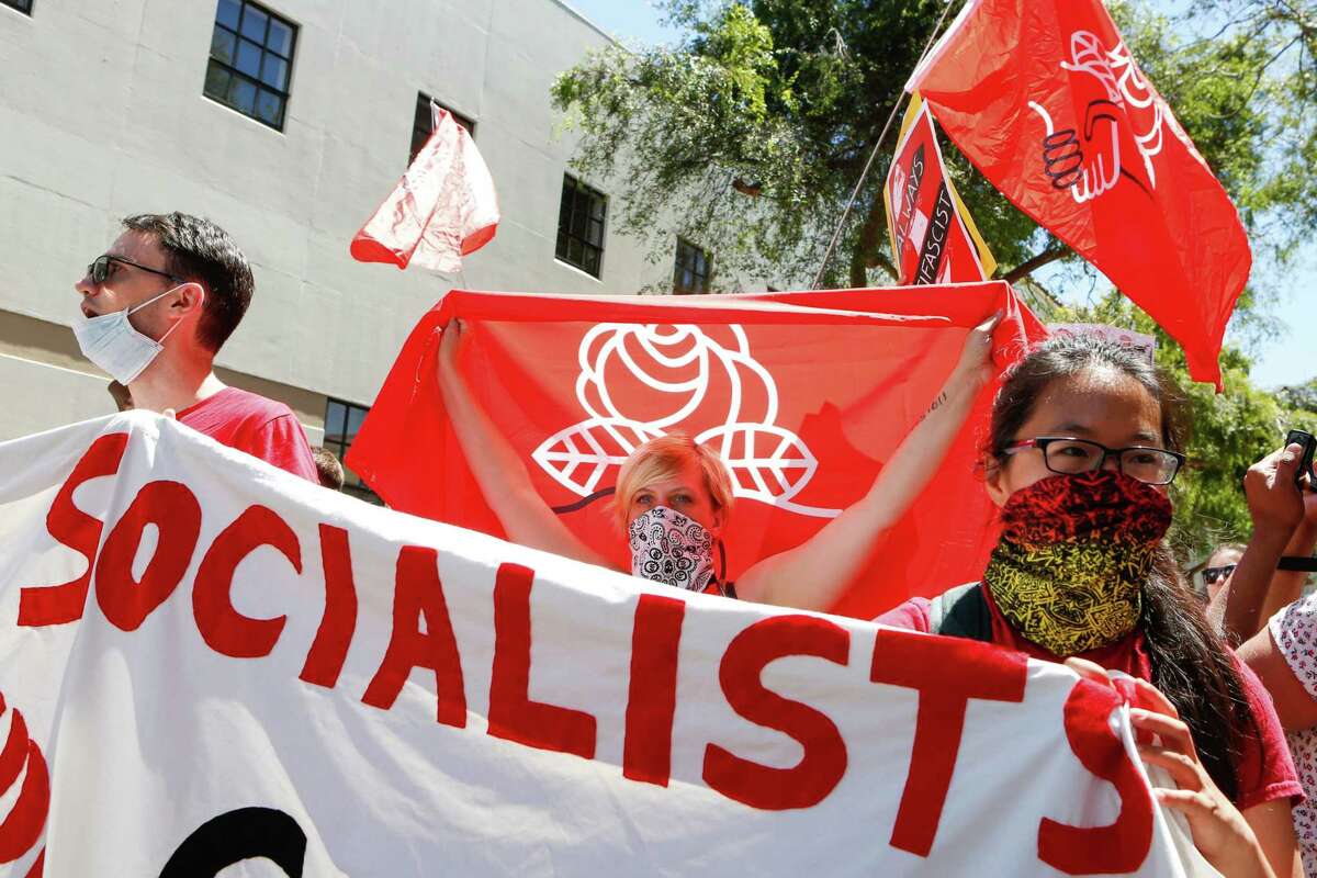 Democratic Socialists of America counter protesters hold signs and flags as they march, protesting an alt-right rally on August 5, 2018 in downtown Berkeley, California.. / AFP PHOTO / Amy OsborneAMY OSBORNE/AFP/Getty Images