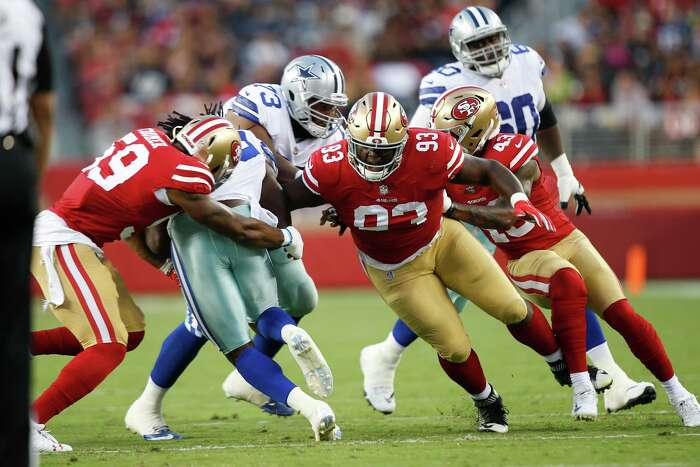 In this Dec. 10, 2017, file photo, San Francisco 49ers' Eli Harold (57),  Eric Reid (35) and Marquise Goodwin (11) kneel during the national anthem  before an NFL football game against the