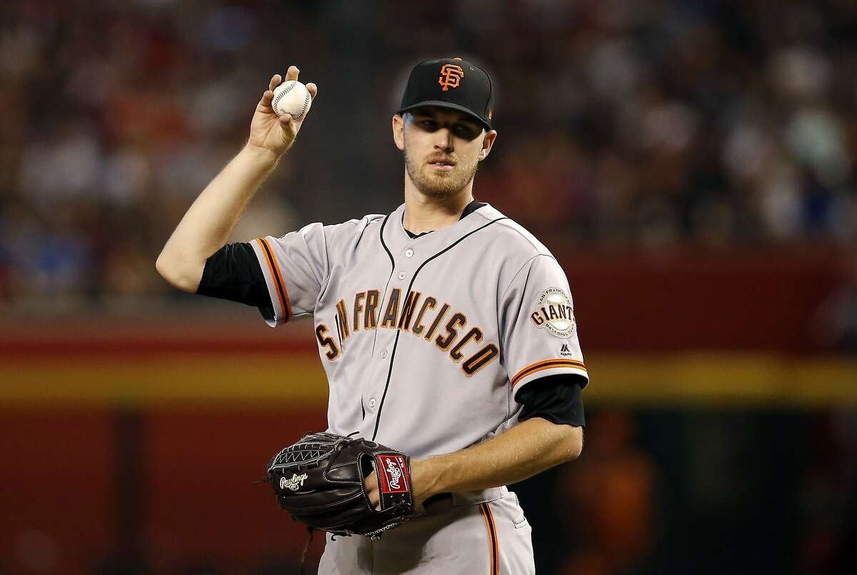 San Francisco Giants starting pitcher Chris Stratton pauses with the baseball during the first inning of a baseball game against the Arizona Diamondbacks Friday, Aug. 3, 2018, in Phoenix. (AP Photo/Ross D. Franklin)