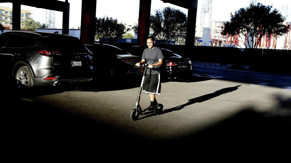 Justine Gonzales rides in the parking lot by "the Pearl". City staff presented a set of recommendations Monday to the City Council's Transportation Committee, including a proposal that electric scooters follow the same laws as bicycles. That includes staying off sidwalks. But Chairman Rey Saldana said that's a no-go for him.