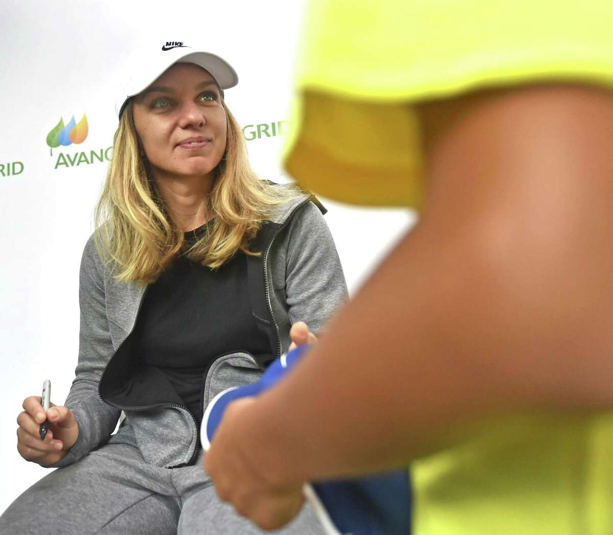 WTA tennis player Simona Halep, the No. 1 ranked player in the world, signs autographs Monday at the Connecticut Open at the Connecticut Tennis Center in New Haven.