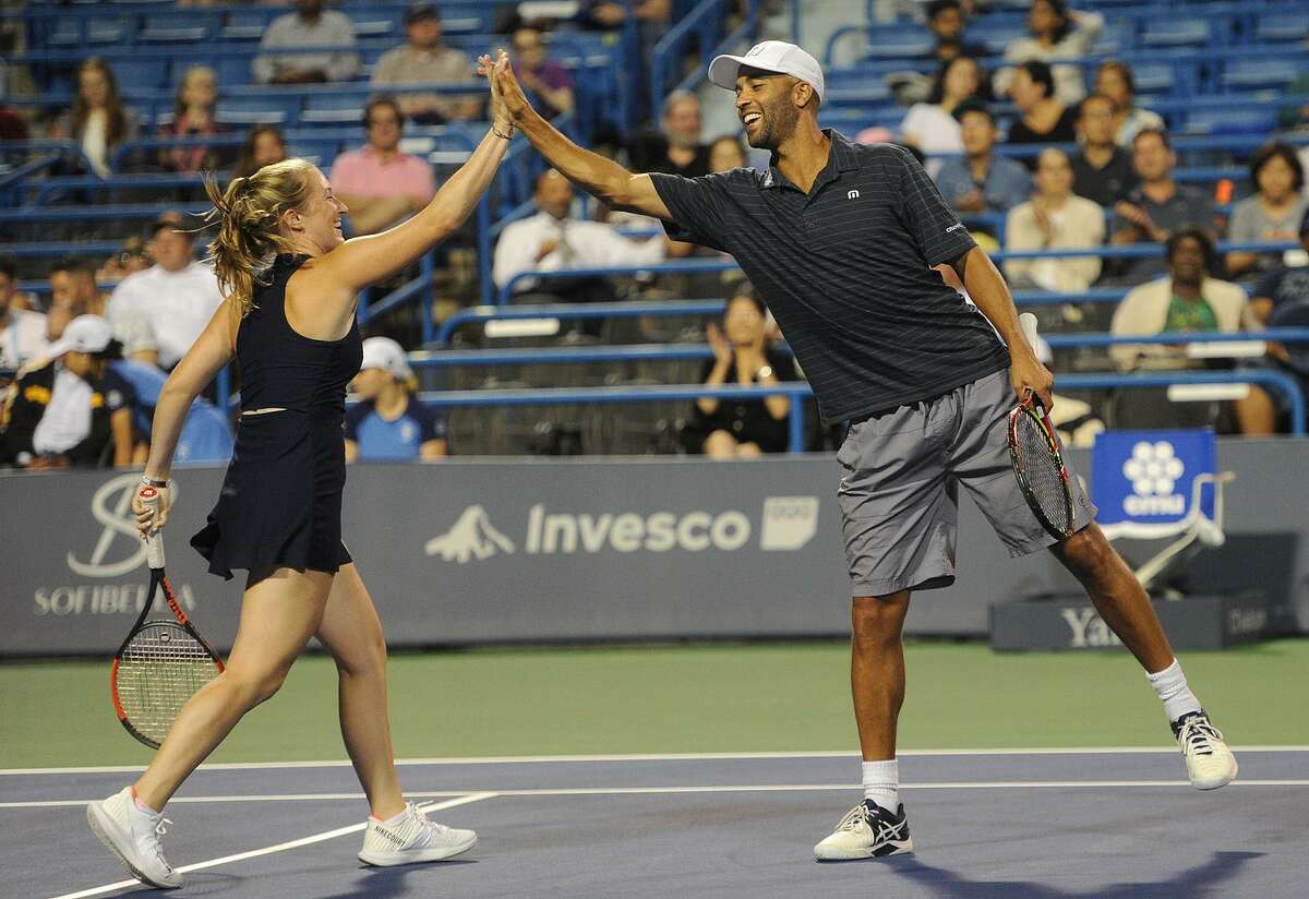 James Blake and Yale tennis team partner Caroline Dunleavy, of Darien, celebrate winning a point during their mixed doubles legends match with Lindsay Davenport and Yale partner Michael Sun, 18, of Livingston, NJ, at the Connecticut Open tennis tournament in New Haven, Conn. on Monday, August 20, 2018.