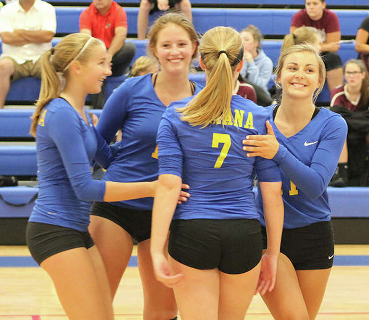 Roxana’s (from left) Macie Lewis, Darcey McGuire, Taylor Jackson (7) and Abby Kurth celebrate a point against Calhoun on Monday at the Roxana Tourney.