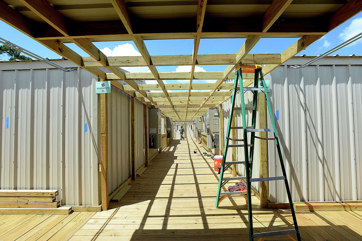 Construction continues at the new portables which will serve Vidor MIddle School sixth graders and staff at the Vidor Junior HIgh School campus. Fifth graders will be in portables at the high school. The Middle School was one of two campuses Vidor ISD lost in Harvey's flooding, and the district is still awaiting word from FEMA on how much they will receive to remodel or build anew. The 10 portable units started arriving in June, and construction crews have been putting them together within the last two weeks, doing the plumbing and electrical work and building covered walkways connecting the units. Last year, the district shuffled its two closed campuses among other school buildings, sharing rooms and other facilities in the wake of Harvey's flooding. This year, sixth graders will be at the portables, which they anticipate will be the case for at least 2 years. Monday, August 20, 2018 Kim Brent/The Enterprise