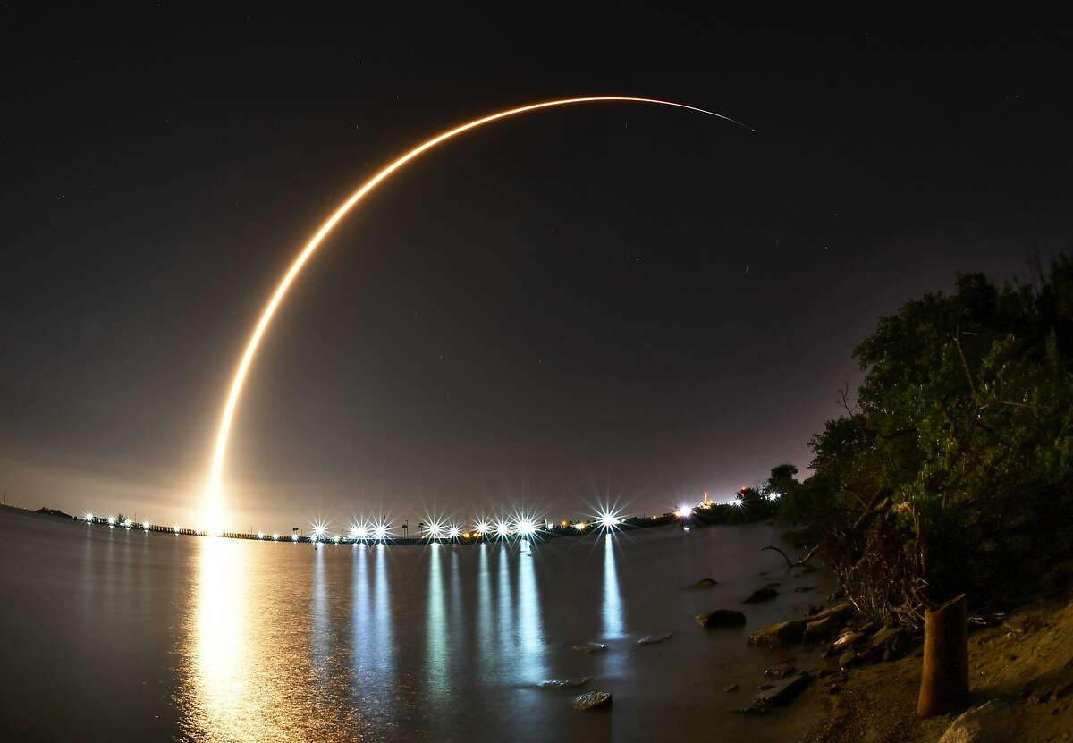 A SpaceX Falcon 9 rocket carrying a Putih/Telkom-4 communications satellite lifts off, early Tuesday, Aug. 7, 2018, from Launch Complex 40 at Cape Canaveral Air Force Station, Fla. The images is a 147-second time exposure of the launch with the lights of the Canaveral Lock in the foreground, reflecting on the water of the Banana River just north of the Beachline near Port Canaveral. (Malcolm Denemark/Florida Today via AP)