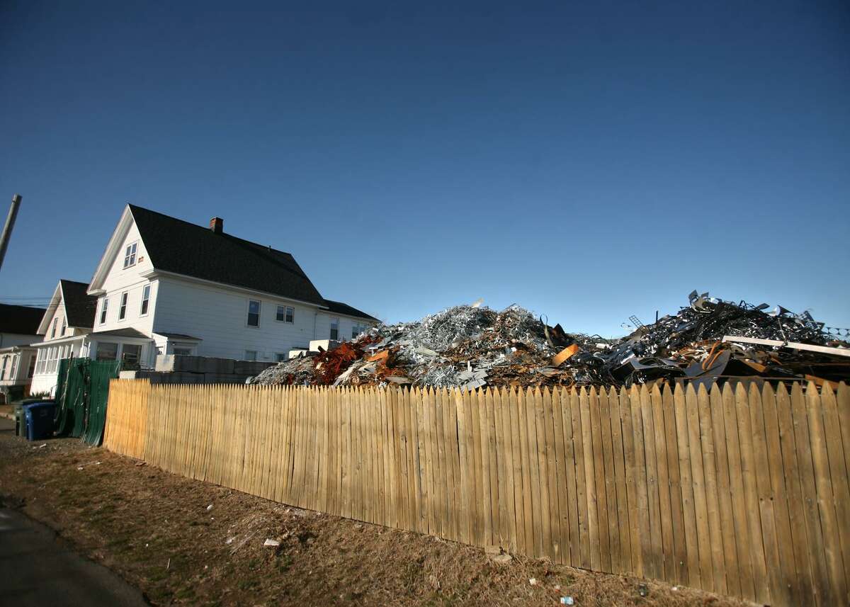 Mountains of scrap metal can be seen towering over a fence along Central Ave. in Bridgeport, Conn. in Februrary of 2012.