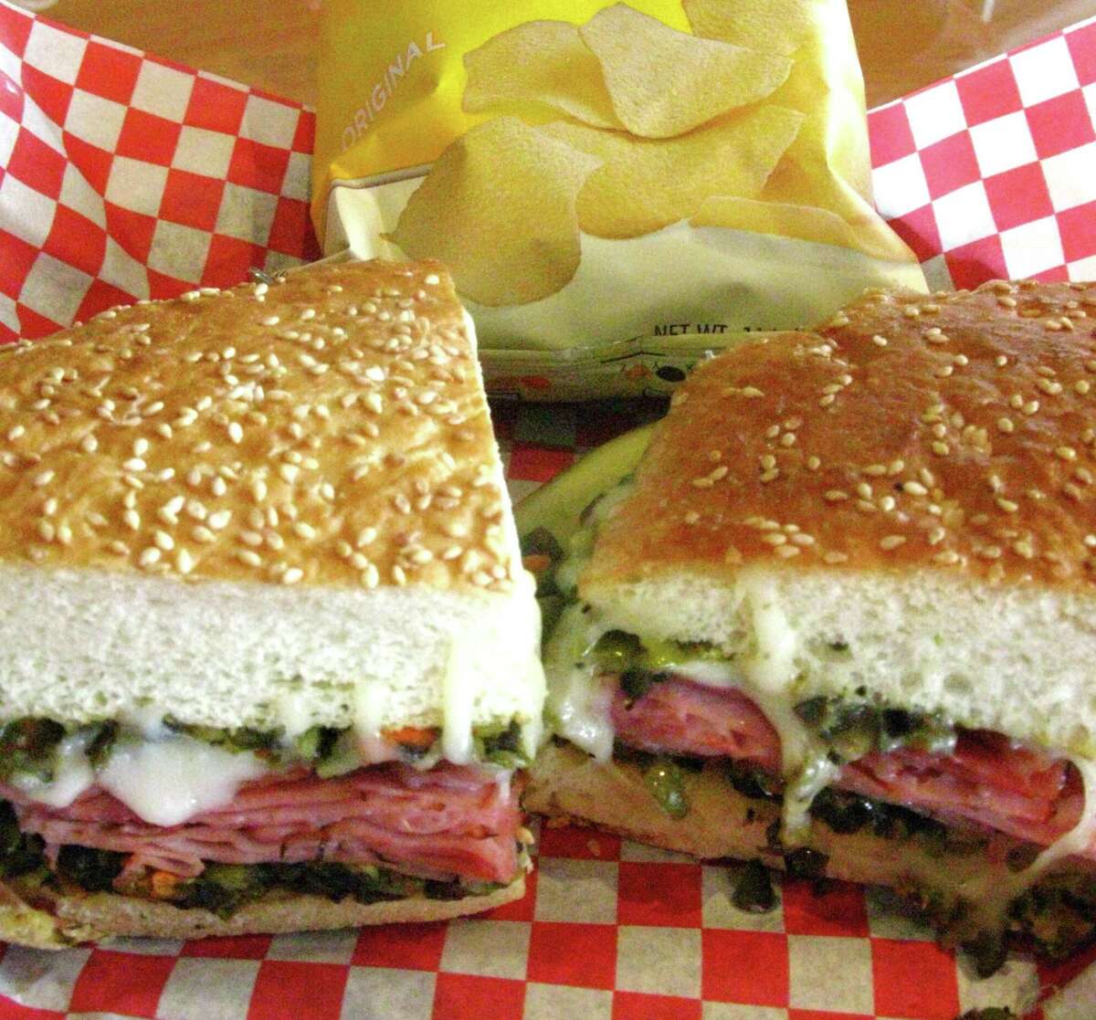 The Hearthstone Lotta Muffaletta from Hearthstone Bakery Cafe is stacked with your choice of ham and salami or turkey, layered with diced olives and veggies, provolone cheese and toasted.