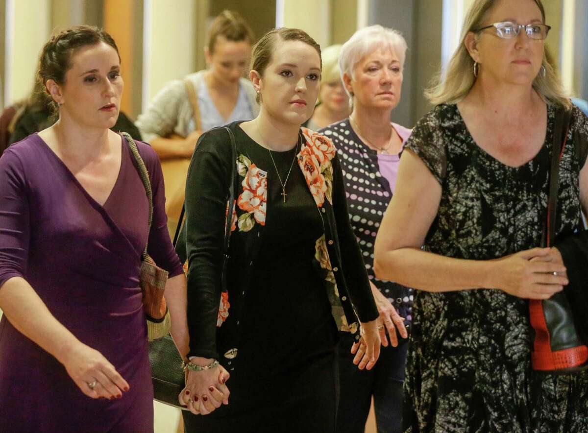 Michelle Schiffer, center, who taught at Cypress Springs High School, arrives for sentencing at the 177th District Criminal Court Tuesday, Aug. 21, 2018 in Houston after pleading guilty to one charge of improper relationship with a student. She admitted to meeting with a former student for sex at least twice during the summer of 2017, according to court records.