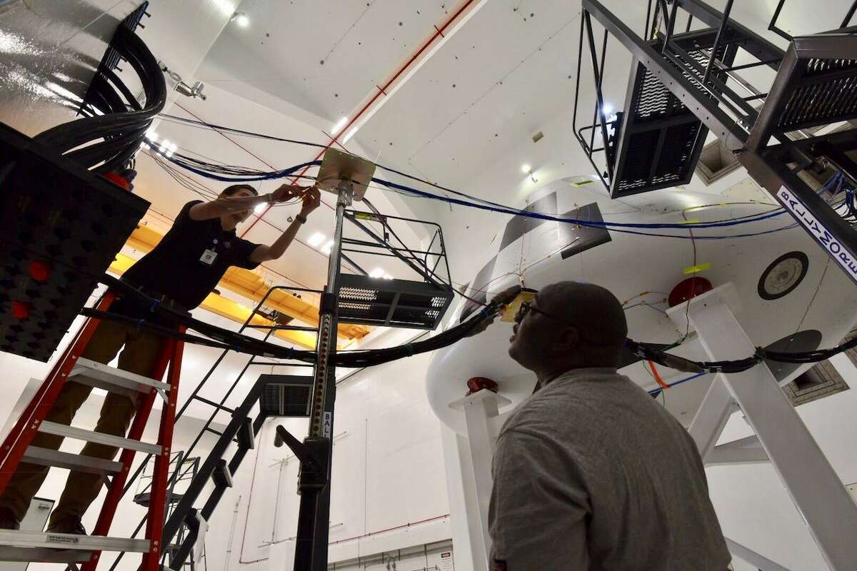 NASA personnel connect power and sensor cables used to track data during acoustic testing at NASA Glenn Research Center’s Plum Brook Station in Sandusky, Ohio, on Aug. 21, in preparation for Orion’s Ascent Abort-2 test.