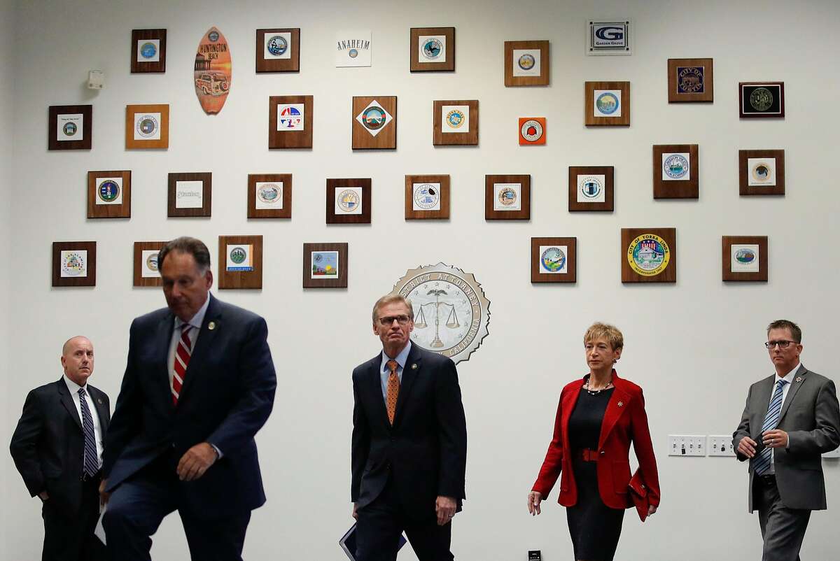 Orange County District Attorney Tony Rackauckas, from left, Ventura County District Attorney Gregory Totten, Santa Barbara County District Attorney Joyce Dudley and Tulare County District Attorney Tim Ward arrive for a news conference Tuesday, Aug. 21, 2018, in Santa Ana, Calif. A former police officer accused of being Golden State Killer will be tried in Sacramento County on more than a dozen murders committed up and down the state that terrorized residents during the 1970s and '80s. (AP Photo/Jae C. Hong)