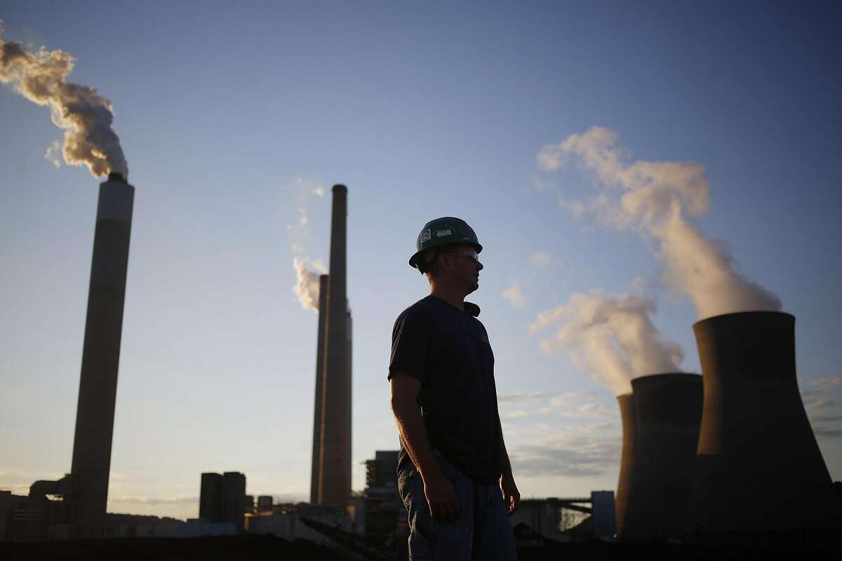 A worker stands in the coal yard at the American Electric Power Co. (AEP) coal-fired John E. Amos Power Plant in Winfield, West Virginia, U.S., on Wednesday, July 18, 2018. American Electric Power Co., Duke Energy Corp., and others say they can't recoup money they spent to meet requirements to cut mercury and other air toxics from their facilities and therefore want the Environmental Protection Agency (EPA) to retain the Mercury and Air Toxics Standards (MATS) rule as is. Photographer: Luke Sharrett/Bloomberg