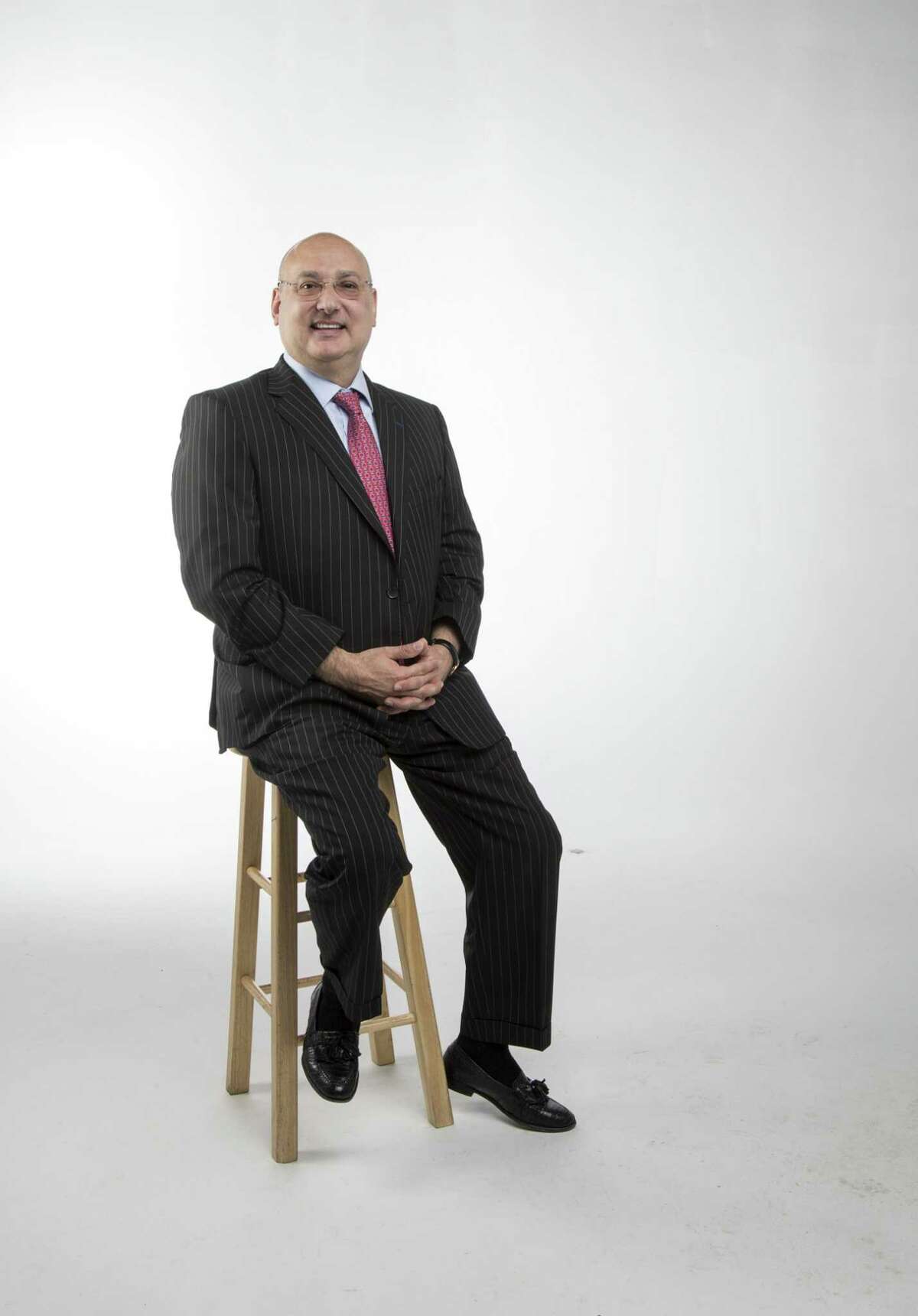 Gilbert Garcia, managing partner of Garcia, Hamilton and Associates, poses for a portrait in the Houston Chronicle photo studio Tuesday, Aug. 14, 2018, in Houston.