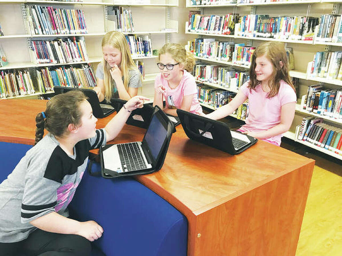 Mount Olive third-grade students, left to right, Alexis Mielke; Jennifer Kofowski; Ava Baumberger; and, Jada Foster work together as a cooperative group on their Chromebooks, while seated comfortable among the Mount Olive public school library, recently transformed to a modern media center. Approximately 50 volunteers did the work to revitalize the school library.