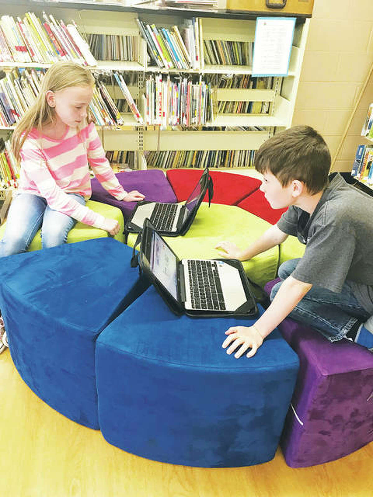 Fourth-grade students Claire Settles and Tucker Durbin work together on their Chromebooks, seated comfortably, which was a major priority when it came to students’ wants for the new library media center. Teachers visited classrooms and placed suggestion boxes for youngsters’ ideas, all of which were read, Mount Olive reading teacher Mary Griffel said.