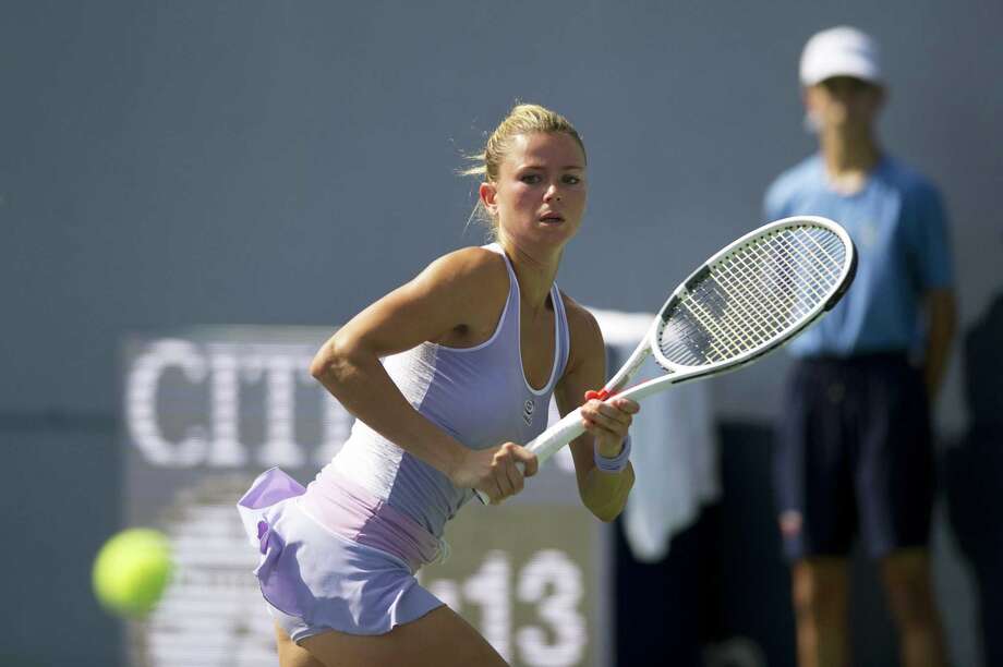camila giorgi of italy chases down the ball before hitting a