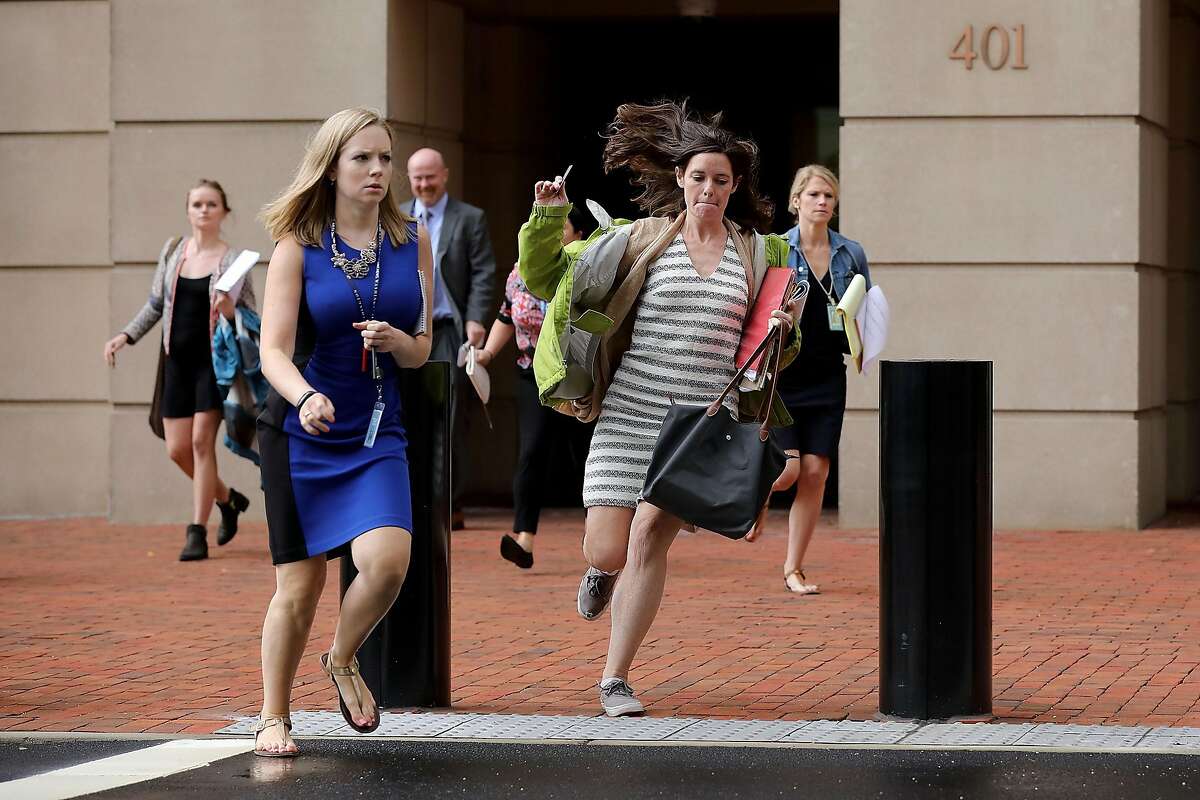 ALEXANDRIA, VA - AUGUST 21: Journalists run out of the Albert V. Bryan U.S. Courthouse during the trial of former Trump campaign chairman Paul Manafort during the fourth day of jury deliberation August 21, 2018 in Alexandria, Virginia. Manafort has been charged with bank and tax fraud as part of special counsel Robert Mueller's investigation into Russian interference in the 2016 presidential election. (Photo by Chip Somodevilla/Getty Images)