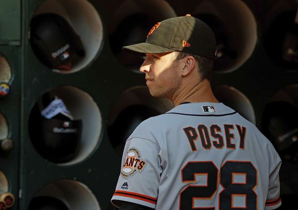 BUSTER POSEY OAKLAND, CA - JULY 20: Buster Posey #28 of the San Francisco Giants stands in the dugout before the game against the Oakland Athletics at the Oakland Coliseum on July 20, 2018 in Oakland, California. The San Francisco Giants defeated the Oakland Athletics 5-1. (Photo by Jason O. Watson/Getty Images)