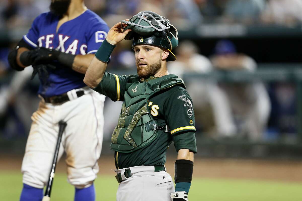 Oakland Athletics catcher Jonathan Lucroy looks to the dugout during a baseball game against the Texas Rangers, Tuesday July 24, 2018, in Arlington, Texas. (AP Photo/Roger Steinman)