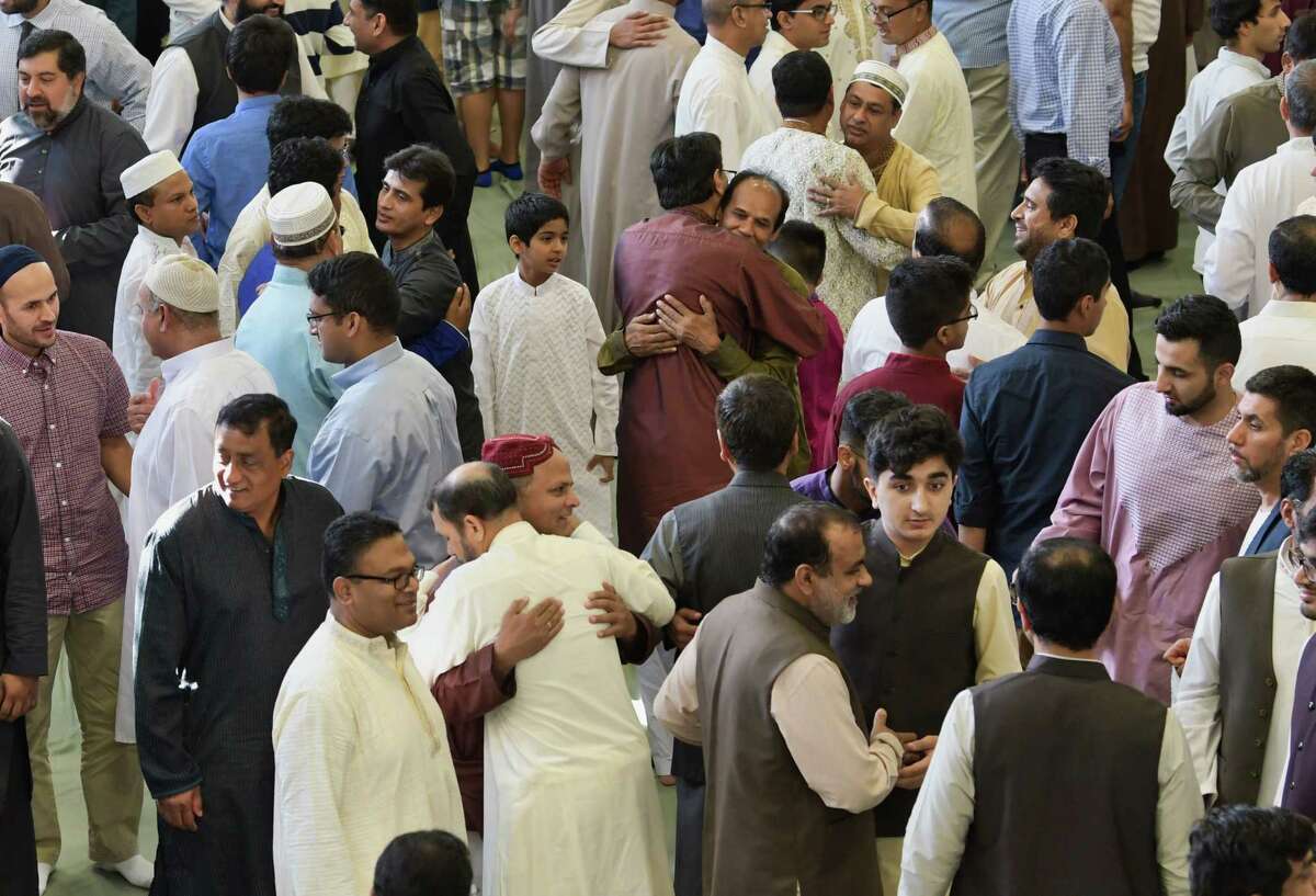 Muslims embrace each other following prayers to celebrate Eid ul Adha at the Islamic Center of the Capital District on Tuesday, Aug. 21, 2018, in Colonie, N.Y. (Paul Buckowski/Times Union)