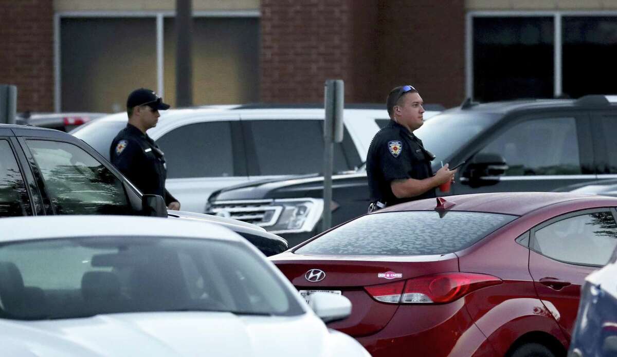 Law enforcement officers patrol a parking lot at Santa Fe High School on the first day of the new school year Monday, Aug. 20, 2018.