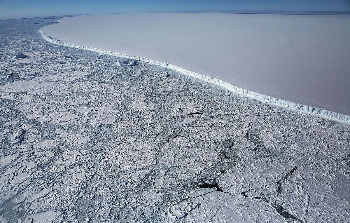 The western edge of the famed iceberg A-68 (TOP R), calved from the Larsen C ice shelf, is seen from NASA's Operation IceBridge research aircraft, near the coast of the Antarctic Peninsula region, on October 31, 2017, above Antarctica. The massive iceberg was measured at approximately the size of Delaware when it first calved in July. NASA's Operation IceBridge has been studying how polar ice has evolved over the past nine years and is currently flying a set of nine-hour research flights over West Antarctica to monitor ice loss aboard a retrofitted 1966 Lockheed P-3 aircraft. According to NASA, the current mission targets 'sea ice in the Bellingshausen and Weddell seas and glaciers in the Antarctic Peninsula and along the English and Bryan Coasts.' Researchers have used the IceBridge data to observe that the West Antarctic Ice Sheet may be in a state of irreversible decline directly contributing to rising sea levels. The National Climate Assessment, a study produced every 4 years by scientists from 13 federal agencies of the U.S. government, released a stark report November 2 stating that global temperature rise over the past 115 years has been primarily caused by 'human activities, especially emissions of greenhouse gases'. (Photo by Mario Tama/Getty Images)