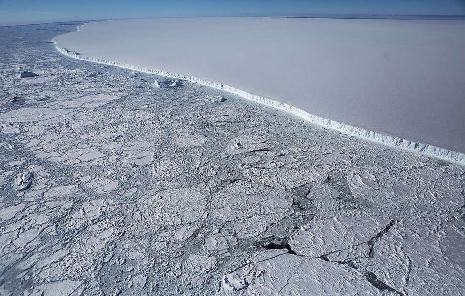 The western edge of the famed iceberg A-68 (TOP R), calved from the Larsen C ice shelf, is seen from NASA's Operation IceBridge research aircraft, near the coast of the Antarctic Peninsula region, on October 31, 2017, above Antarctica. The massive iceberg was measured at approximately the size of Delaware when it first calved in July. NASA's Operation IceBridge has been studying how polar ice has evolved over the past nine years and is currently flying a set of nine-hour research flights over West Antarctica to monitor ice loss aboard a retrofitted 1966 Lockheed P-3 aircraft. According to NASA, the current mission targets 'sea ice in the Bellingshausen and Weddell seas and glaciers in the Antarctic Peninsula and along the English and Bryan Coasts.' Researchers have used the IceBridge data to observe that the West Antarctic Ice Sheet may be in a state of irreversible decline directly contributing to rising sea levels. The National Climate Assessment, a study produced every 4 years by scientists from 13 federal agencies of the U.S. government, released a stark report November 2 stating that global temperature rise over the past 115 years has been primarily caused by 'human activities, especially emissions of greenhouse gases'.  (Photo by Mario Tama/Getty Images) Photo: Mario Tama, Getty Images