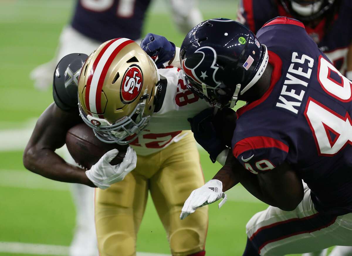 San Francisco 49ers wide receiver Richie James (82) cathes a pass against Houston Texans linebacker Josh Keyes (49) during the third quarter of an NFL preseason football game at NRG Stadium on Saturday, Aug. 18, 2018, in Houston.