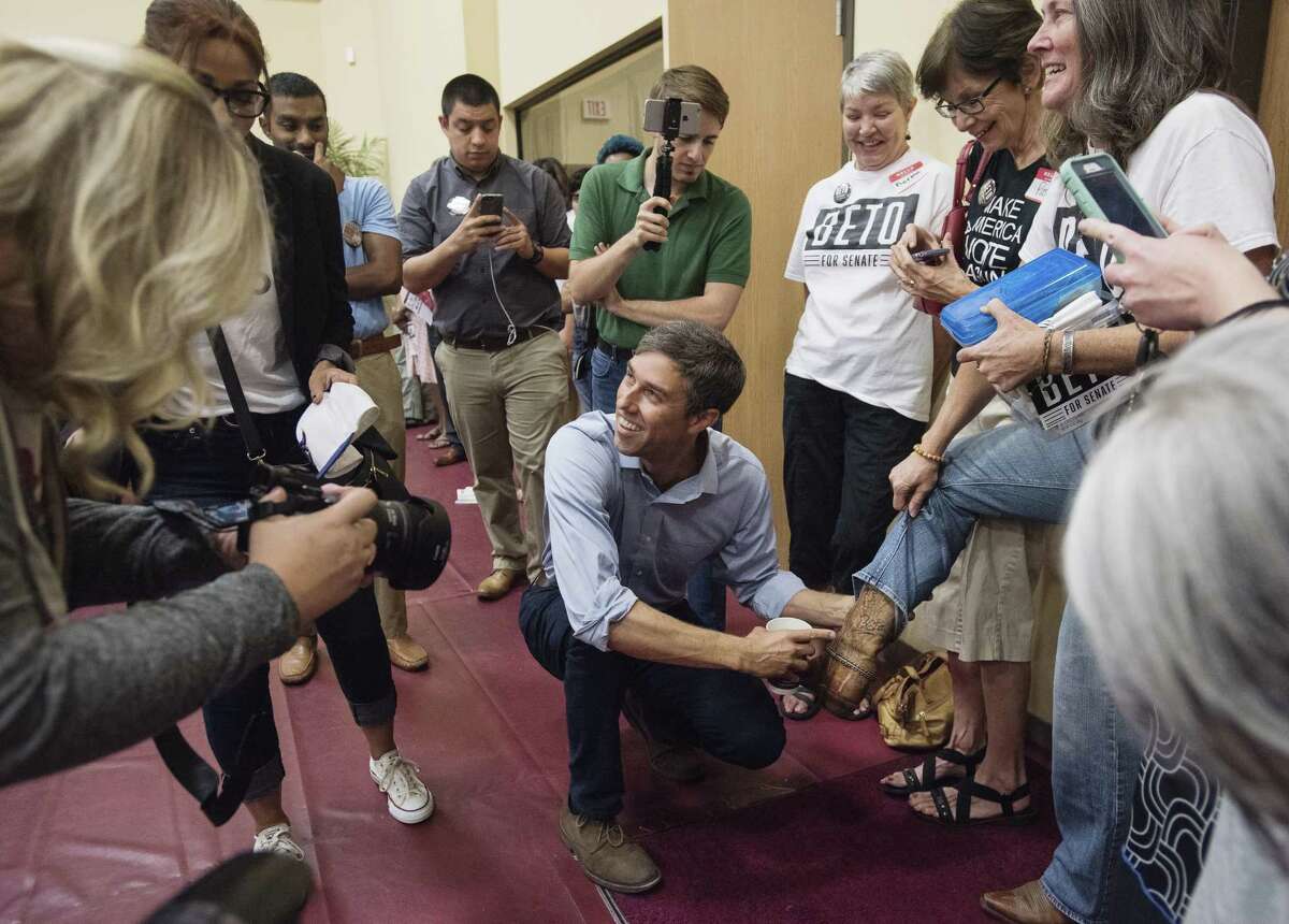 Beto O'Rourke, D-El Paso, points to his autograph on the boot of Staci Oller Smith of Tyler during his campaign stop at St. Louis Baptist Church in Tyler, Texas, on Monday Aug. 13, 2018. O'Rourke signed the boot over a year ago at a campaign stop at Don Juan's Restaurant in downtown Tyler. The current U.S. Rep is running for U.S. Senate against Ted Cruz. More than 600 people attended the campaign stop.