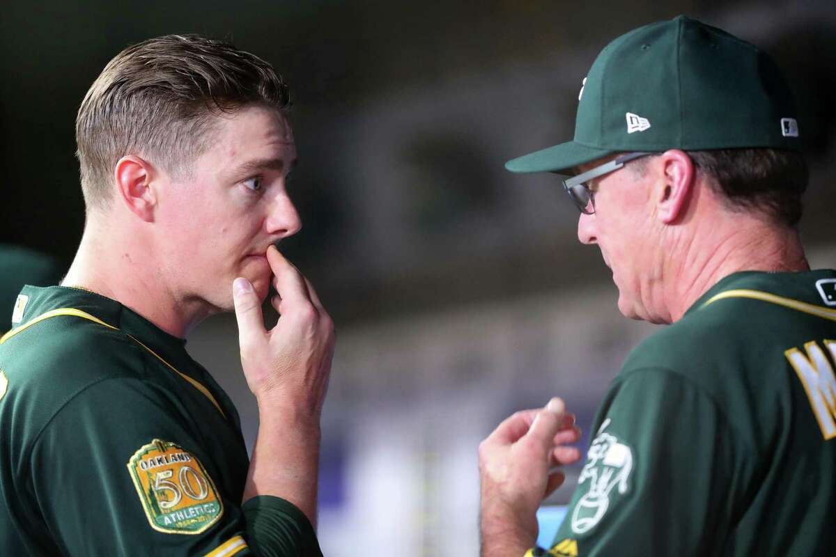 ARLINGTON, TX - JULY 24: Ryan Buchter #52 of the Oakland Athletics talks with Manager Bob Melvin #6 of the Oakland Athletics in the bottom of the sixth inning after being pulled from the game against the Texas Rangers at Globe Life Park in Arlington on July 24, 2018 in Arlington, Texas. (Photo by Tom Pennington/Getty Images)