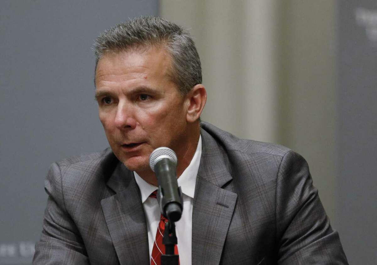 Ohio State football coach Urban Meyer makes a statement during a news conference in Columbus, Ohio, Wednesday, Aug. 22, 2018. Ohio State suspended Meyer on Wednesday for three games for mishandling domestic violence accusations, punishing one of the sport's most prominent leaders for keeping an assistant on staff for several years after the coach's wife accused him of abuse. Athletic director Gene Smith was suspended from Aug. 31 through Sept. 16. (AP Photo/Paul Vernon)