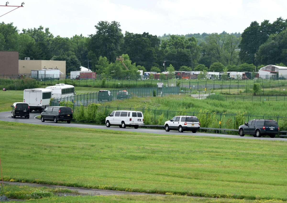 Immigrant men are escorted to Albany County Jail after landing at Albany International Airport on Thursday afternoon, June 28, 2018, in Colonie, N.Y. They were flown in from Arizona on a U.S. Immigration and Customs Enforcement jet. The jail has taken in 235 immigrant men who are being detained on immigration charges. (Will Waldron/Times Union)