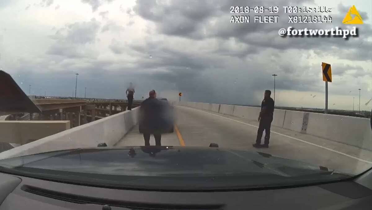 In a dramatic video, two Forth Worth Police officers rescue a woman threatening to jump from an overpass. 
