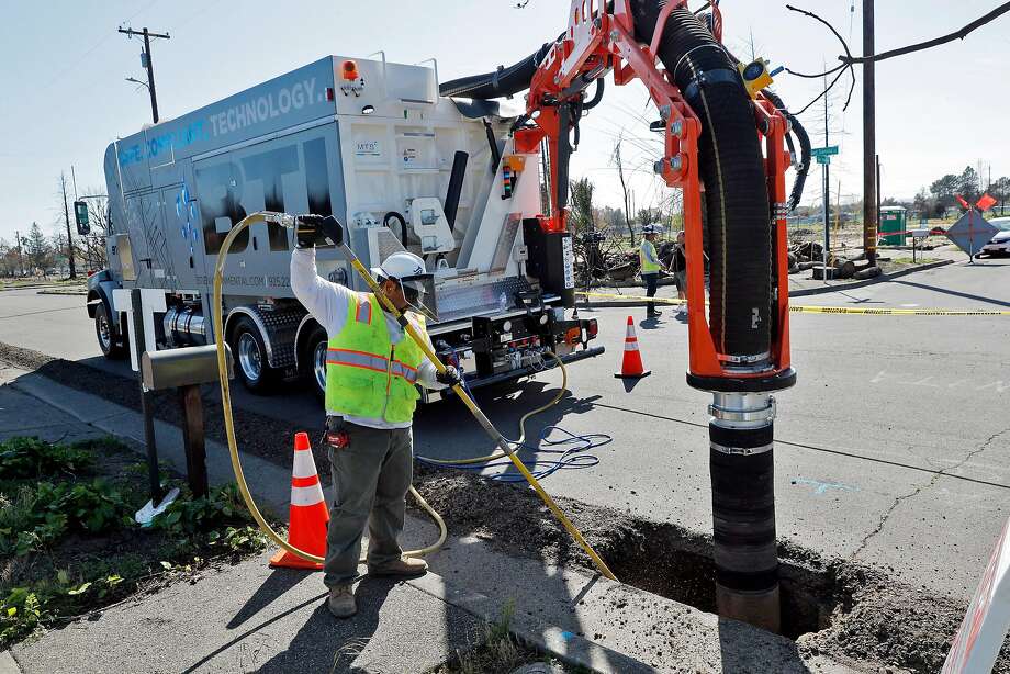 A BTI Environmental contractor works on a trench next to empty home lots as PG&E crews and subcontractors began prepping to for underground utility lines in the Coffey Park neighborhood of Santa Rosa in April. Photo: Carlos Avila Gonzalez / The Chronicle