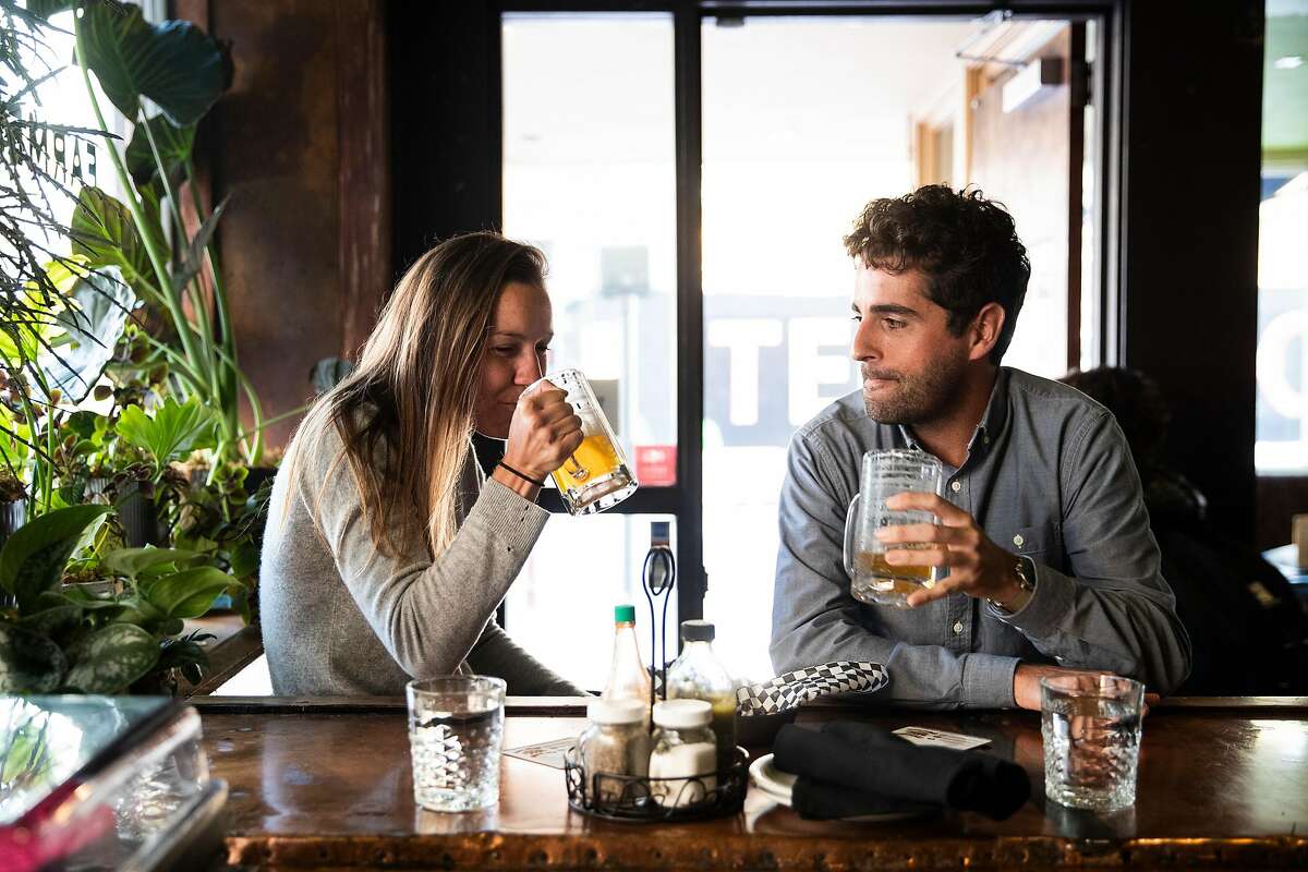 Jessica Huffman, left, and Crosby Freeman enjoy a glass of beer at the bar during dinner service at Farmer Brown in San Francisco, Calif. on Wednesday, Aug. 22, 2018.
