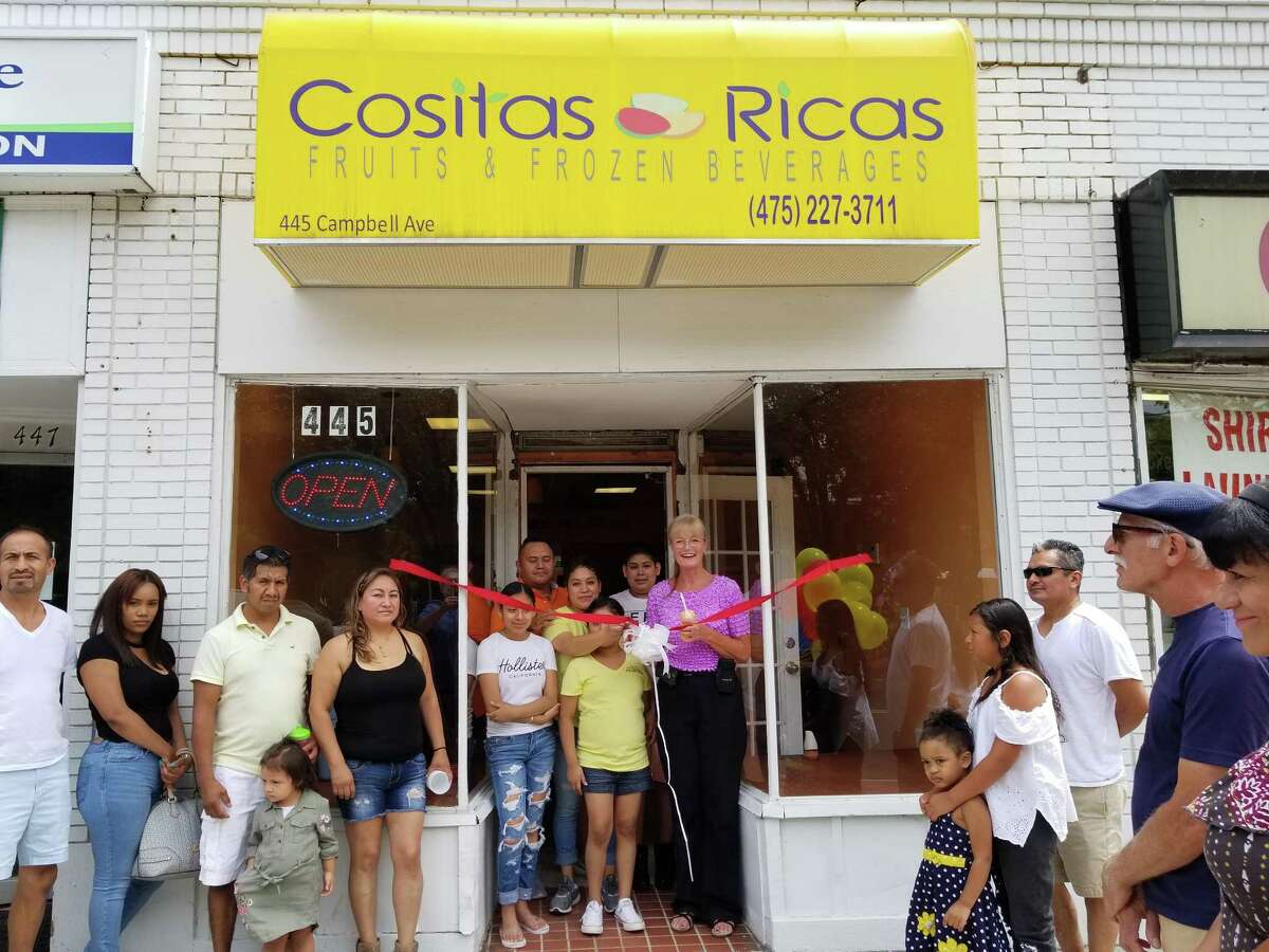 GRAB A BITE: West Haven Mayor Nancy R. Rossi, right, cuts the ribbon with Cositas Ricas owner Pilar Garcia Leon to celebrate the ceremonial opening of the fruit and frozen beverage shop at 445 Campbell Ave. Garcia is accompanied by her husband, Joan Cuapio, and her children, from left, Ashley Aguila Garcia, 14, Leslie Aguila Garcia, 9, and Francisco Aguila Garcia, 12. In a plaza across the street from the city Green, the new shop blends fresh fruits and fruit salads with creamy milkshakes and smoothies. Cositas Ricas also whips up authentic Latin American dishes, including quesadillas and tacos, along with sandwiches.