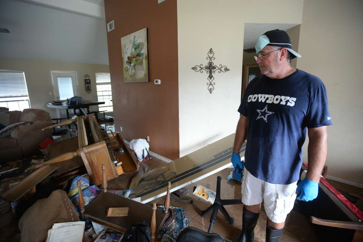 Frankie Hare pauses to look at his water soaked living room while cleaning at his Northwest Forest home on Tuesday. Residents were allowed back into the area Tuesday morning to begin cleaning out their homes. Photo taken Tuesday, September 05, 2017 Guiseppe Barranco/The Enterprise