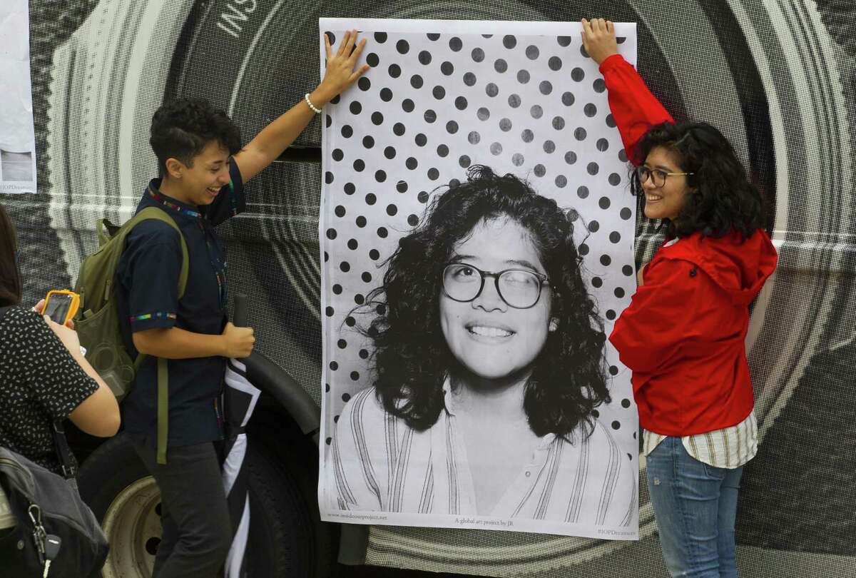 Charli Diaz, a student at the University of Houston Downtown, helps Sabrina Juarez, a University of Houston student, hold up a freshly printed poster of a photo the Inside Out Project's mobile photo booth had just taken of Juarez at the University of Houston, in 2017. The exhibit is intended to urge Congress to pass the DREAM act before the end of the year. It hasn’t and the program’s fate lies with the courts.