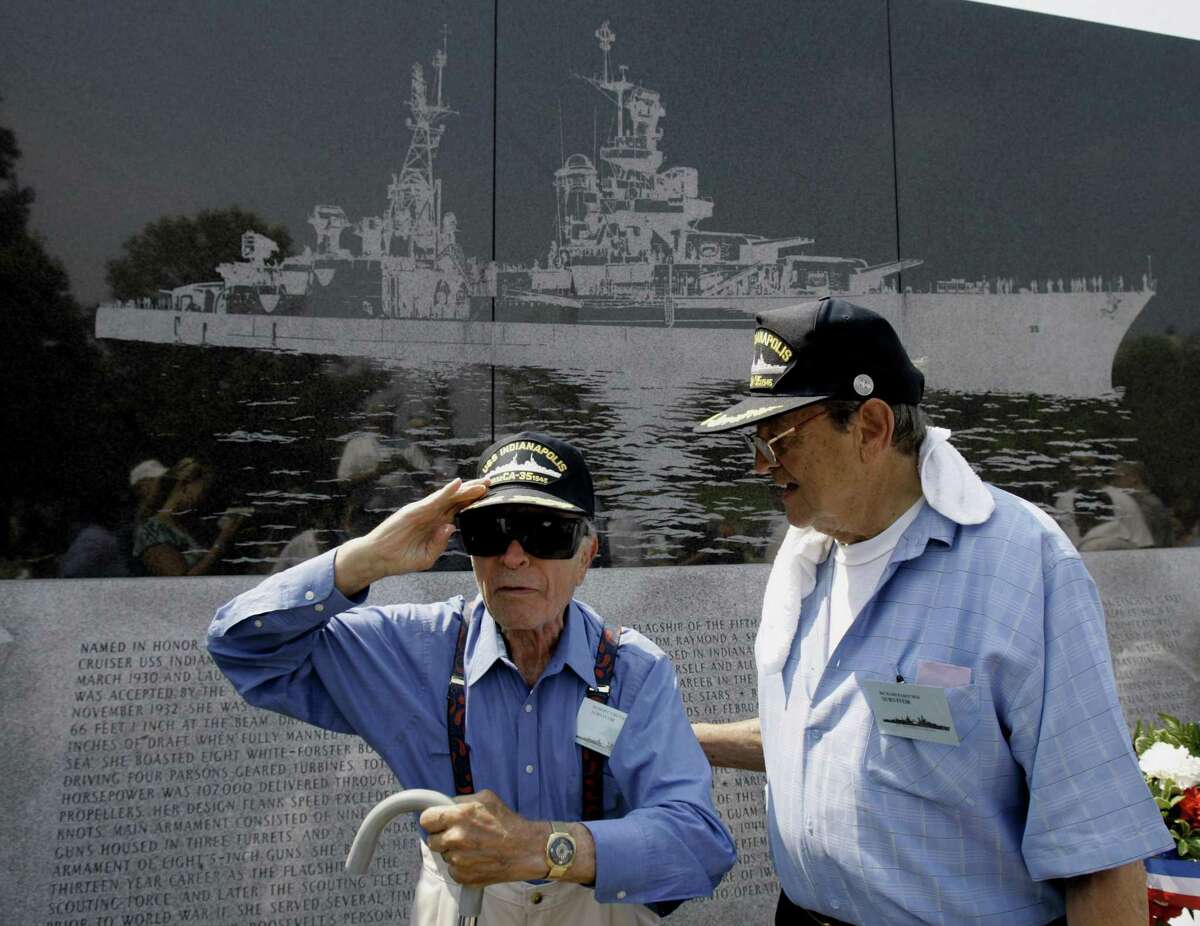 USS Indianapolis survivor Robert Bunai, left, salutes the American flag while Harlod Bray Jr. stands beside him following a memorial service in Indianapolis July 24, 2005. The commander of the Indianapolis, Capt. Charles McVay III, was court-martialed for not sailing a zigzag course to evade submarines. His men believe he was made a scapegoat. In 2000, 32 years after McVay committed suicide, Congress passed an act clearing his name.