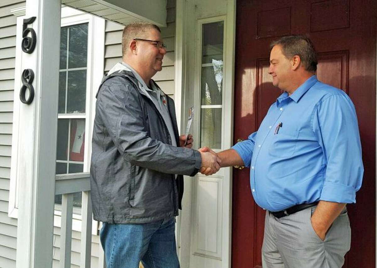 Retired Middletown Police Capt. Sean Moriarty, left, greets a voter in late 2017, ahead of Election Day. His bid for First Selectman Lizz Milardo’s post was unsuccessful in his hometown of Haddam.