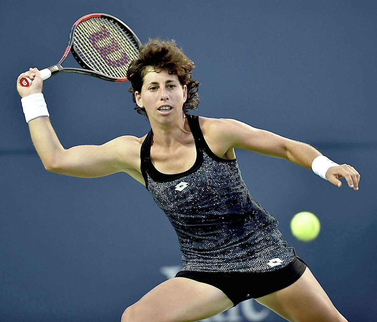 Carla Suarez Navarro returns a shot to Monica Puig during their semifinal match at the Connecticut Open on Friday.