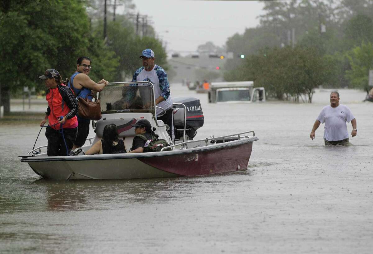 Neighbors with boats aid in rescues near FM 2351 and FM 518 Sunday, Aug. 27, 2017, in Friendswood.