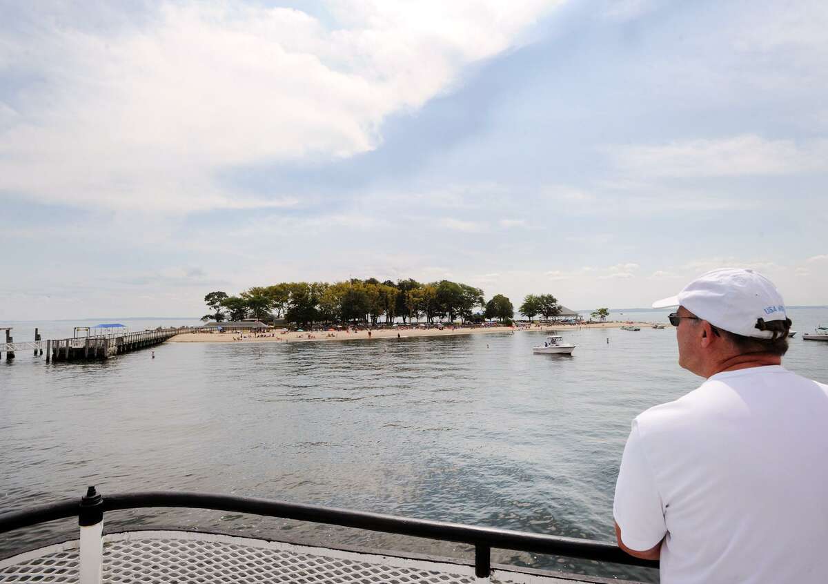 Bill Wright of Greenwich looks toward Island Beach from the bow of the Island Beach ferry in Long Island Sound off the island that is part of Greenwich, Conn., Saturday, August 25, 2018, on the day the town celebrated the 100th anniversary of the island's donation to the town. Wright said his great grandfather, Blanchard Gardner, was one of the original captains of the Island Beach ferry.