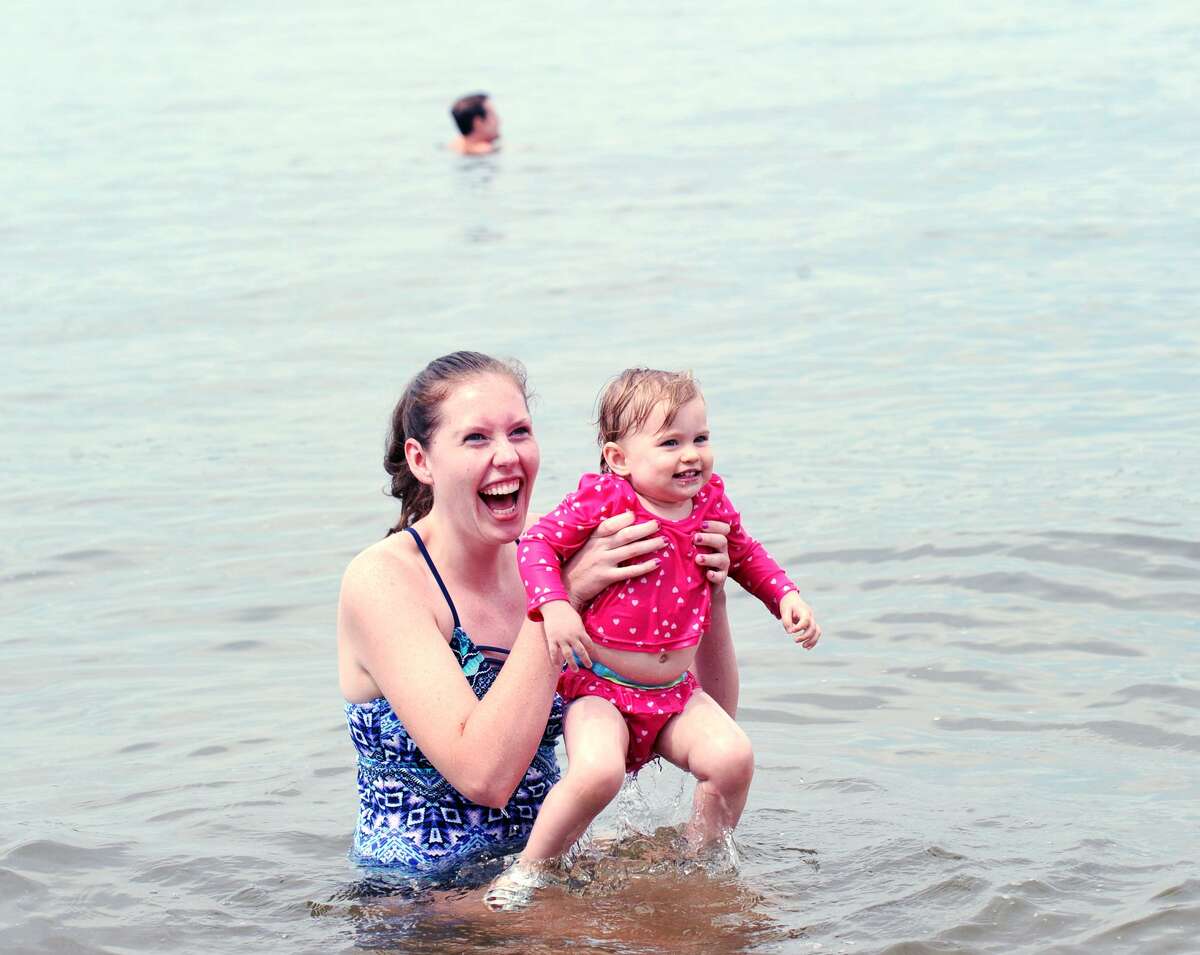 Danielle Deehand of Greenwich played with her niece Molly Deehand, 16-months-old, in Long Island Sound at Island Beach off the coast of Greenwich, Conn., Saturday, August 25, 2018, on the day a ceremony was held commemorating the 100th anniversary of when the island, that is used as a public beach, was donated to the Town of Greenwich in 1918.