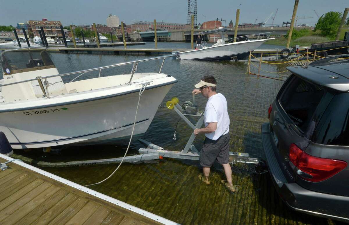 Norwalk resident Bob Minion launches his boat in May from the new Norwalk Visitor’s Docks at Veterans Memorial Park. Eversource plans to relocate two transmission lines that run atop the Walk Bridge and route them under Norwalk Harbor, emerging in the Visitor’s Docks parking lot.