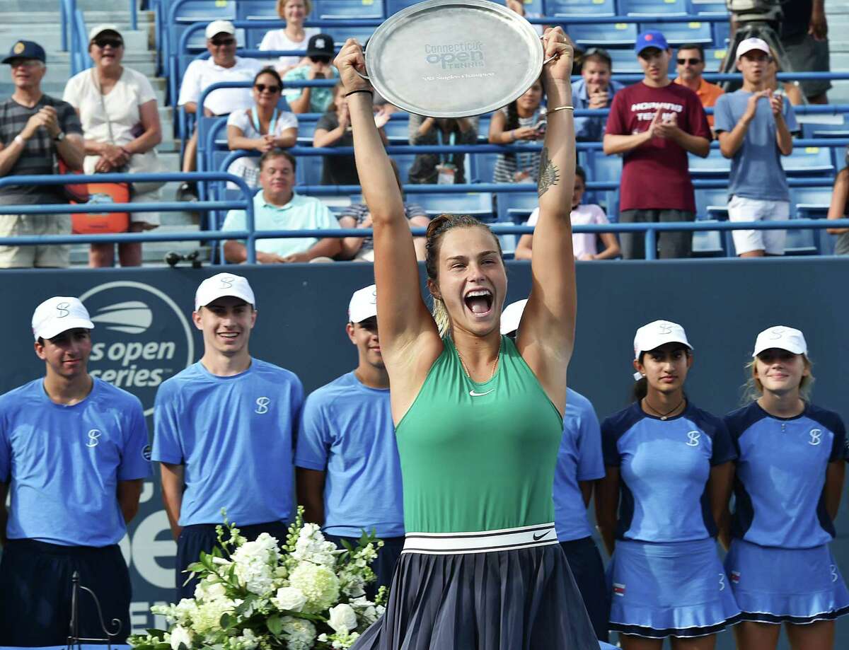 Aryna Sabalenka raises the trophy above her head to celebrate her victory over Carla Suarez Navarro in the Connecticut Open final no Saturday.