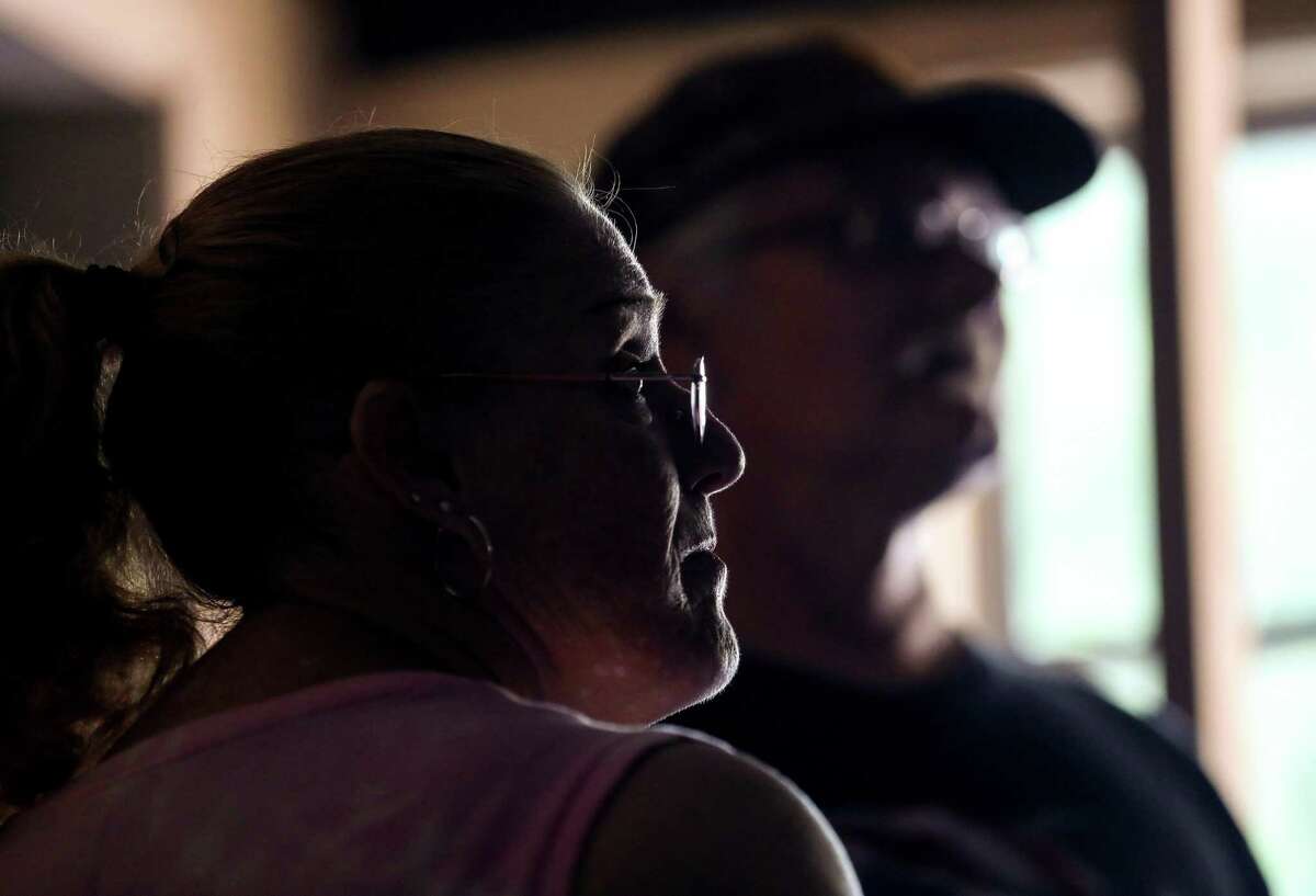 Suzan Trout, and her husband Daniel Trout, talk with volunteers as they repair their Hurricane Harvey-damaged home, Thursday, July 26, 2018, in Houston.