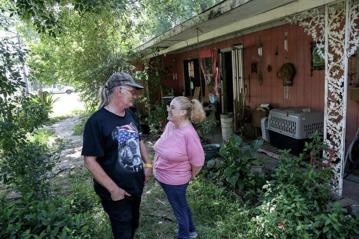 Daniel Trout jokes with his wife of 33 years, Suzan Trout, as their home, which was damaged during Hurricane Harvey is repaired by volunteers, Thursday, July 26, 2018, in Houston.