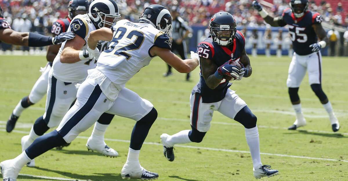 Houston Texans defensive back Kareem Jackson (25) is chased down by Los Angeles Rams tight end Johnny Mundt (82) as he returns an interception of a Sean Mannion pass during the first quarter of an NFL preseason football game at the Los Angeles Memorial Coliseum on Saturday, Aug. 25, 2018, in Los Angeles.